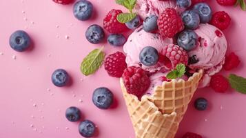 An ice cream cone adorned with blueberries, raspberries, and mint set against a vibrant backdrop, serving as a representation of a cool and fruity summer treat. photo