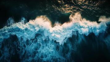 Spectacular aerial top view background photo of ocean sea water white wave splashing in the deep sea. Drone photo backdrop of sea wave in bird eye waves.