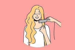 Woman at hairdresser appointment using hair straightener to straighten curls before party or date vector