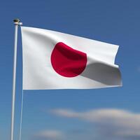 Japan Flag is waving in front of a blue sky with blurred clouds in the background photo