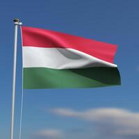 Hungary Flag is waving in front of a blue sky with blurred clouds in the background photo