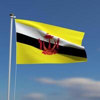 Brunei Flag is waving in front of a blue sky with blurred clouds in the background photo