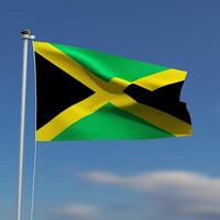 Jamaica Flag is waving in front of a blue sky with blurred clouds in the background photo