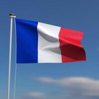 France Flag is waving in front of a blue sky with blurred clouds in the background photo