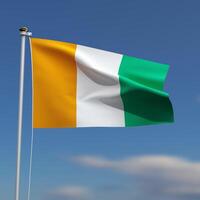 Cote d'Ivoire Flag is waving in front of a blue sky with blurred clouds in the background photo
