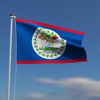 Belize Flag is waving in front of a blue sky with blurred clouds in the background photo