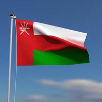 Oman Flag is waving in front of a blue sky with blurred clouds in the background photo