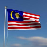 Malaysia Flag is waving in front of a blue sky with blurred clouds in the background photo