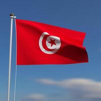 Tunisia Flag is waving in front of a blue sky with blurred clouds in the background photo