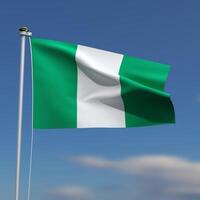 Nigeria Flag is waving in front of a blue sky with blurred clouds in the background photo