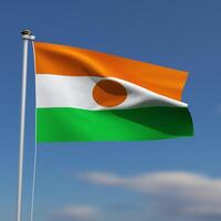 Niger Flag is waving in front of a blue sky with blurred clouds in the background photo