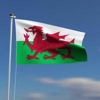Wales Flag is waving in front of a blue sky with blurred clouds in the background photo