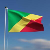 Republic of the Congo Flag is waving in front of a blue sky with blurred clouds in the background photo