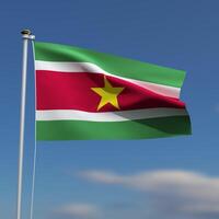 Suriname Flag is waving in front of a blue sky with blurred clouds in the background photo