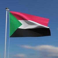 Sudan Flag is waving in front of a blue sky with blurred clouds in the background photo