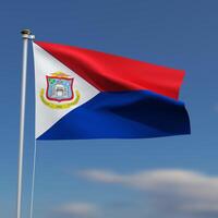 Sint Maarten Flag is waving in front of a blue sky with blurred clouds in the background photo