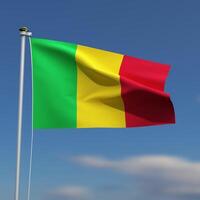 Mali Flag is waving in front of a blue sky with blurred clouds in the background photo