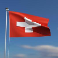 Switzerland Flag is waving in front of a blue sky with blurred clouds in the background photo