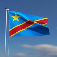 Congo Flag is waving in front of a blue sky with blurred clouds in the background photo