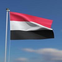 Yemen Flag is waving in front of a blue sky with blurred clouds in the background photo