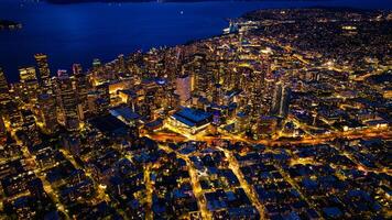 Splendid scenery of the vibrant downtown of Seattle, Washington, the USA. Blue waterscape and evening night at backdrop. photo