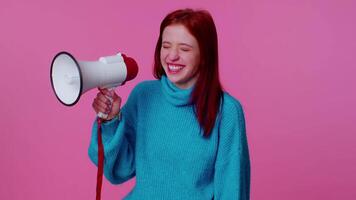 Smiling redhead girl talking with megaphone, proclaiming news, loudly announcing sale advertisement video