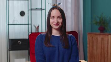 Portrait of happy one beautiful teenager student girl smiling, looking at camera at home on chair video