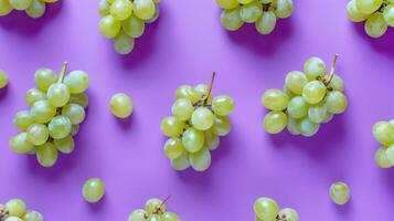 Fresh juicy grapes on a vibrant purple background, arranged in a top view flat lay style display. photo