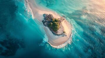 A breathtaking aerial view of a sandy island surrounded by crystal clear Caribbean water. The natural landscape includes a beautiful beach and fluid wind waves photo