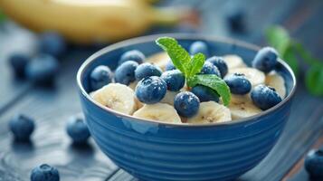 a breakfast bowl with blueberries and bananas, a breakfast bowl with blueberries and bananas. photo