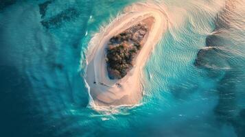 A breathtaking aerial view of a sandy island surrounded by crystal clear Caribbean water. photo