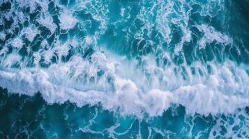 Spectacular aerial top view background photo of ocean sea water white wave splashing in the deep sea.