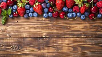 Organic berries such as strawberries, raspberries, blueberries, and cherries displayed on a wooden background photo