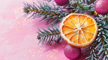 Christmas greeting card with a dried slice of orange on a bright pink background. Homemade decoration. Top view, copy space. photo