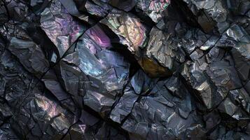 Black rocky surface with iridescent reflections. Black titanium, tourmaline, hematite sample. photo
