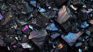 Black rocky surface with iridescent reflections. Black titanium, tourmaline, hematite sample. photo
