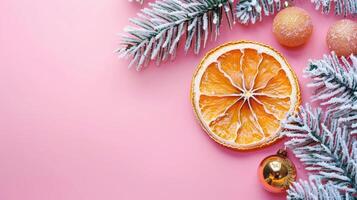 Christmas greeting card with a dried slice of orange on a bright pink background. Homemade decoration. Top view, copy space photo