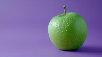 Fresh ripe green apple in purple background photo