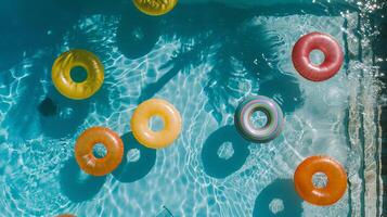 Overhead view of a swimming pool with pool ring floats photo