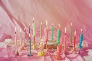 Colorful Birthday Candles on Pink Background photo