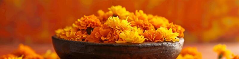 A bowl of orange flowers sits on a table photo