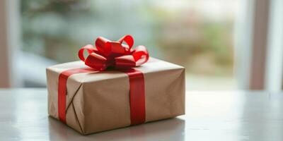 Simple Elegant Gift Wrapped in Brown Paper with Red Ribbon photo