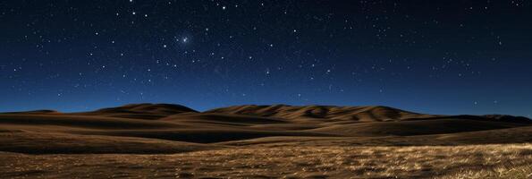 A starry night sky with a large hill in the background photo