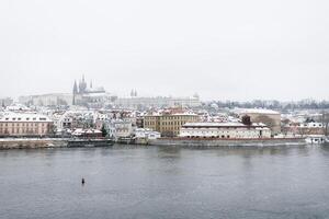 nieve en praga, raro frío invierno condiciones. Praga castillo en checo república, Nevado clima con edificios foto