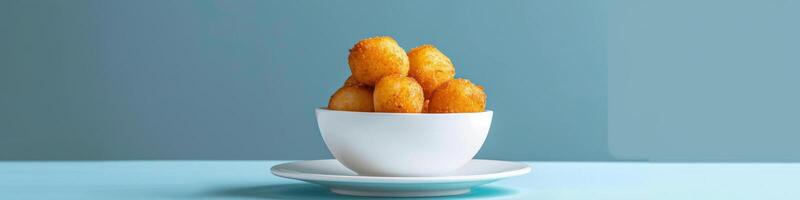 Minimalist Setting with White Ceramic Bowl of Fried Dough Balls photo