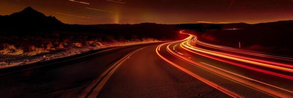 A long road with a mountain in the background photo