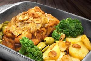 breaded oven cod with broccoli and sliced garlic photo