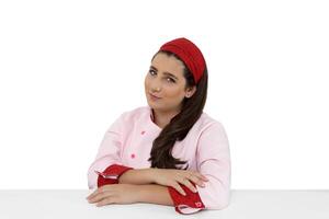 young and friendly chef posing on white background photo