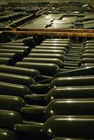 Barrels and bottles of wine in a winery cellar in southern Brazil photo