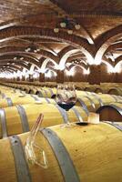 Barrels and bottles of wine in a winery cellar in southern Brazil photo